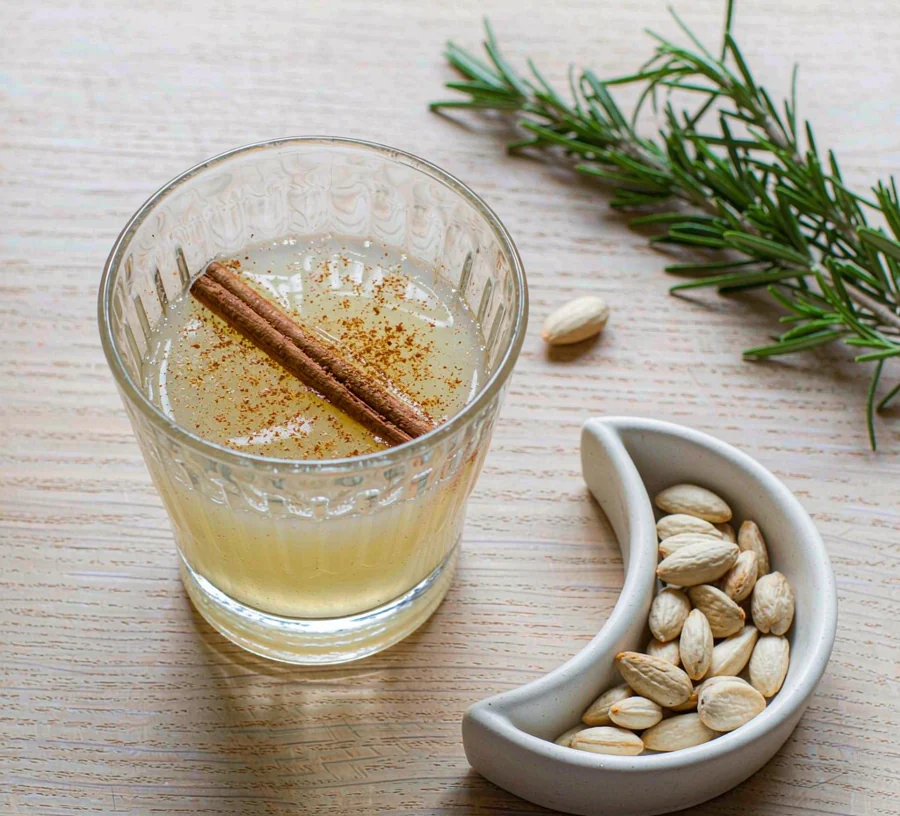 Glass of golden low-calorie eggnog with cinnamon