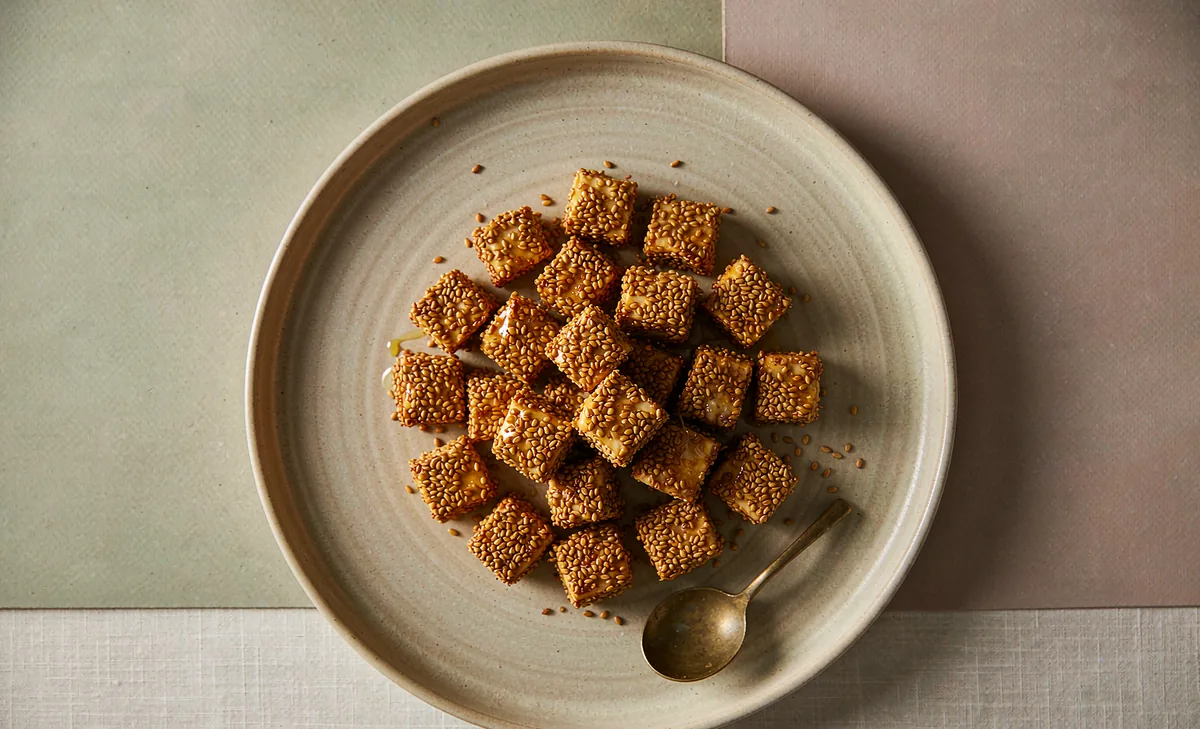 Golden sesame-crusted halloumi bites with honey-miso glaze