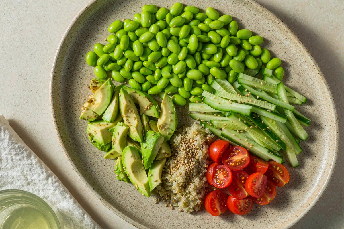 No-cook edamame and avocado bowl — shelled edamame, avocado, cucumber and a lemon dressing in a shallow bowl