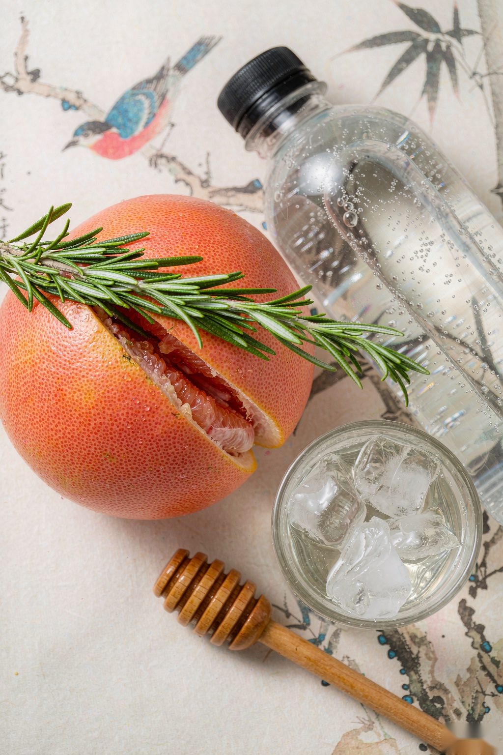 Grapefruit Rosemary Sparkling Water ingredients flat lay: pink grapefruit, rosemary, sparkling water and ice