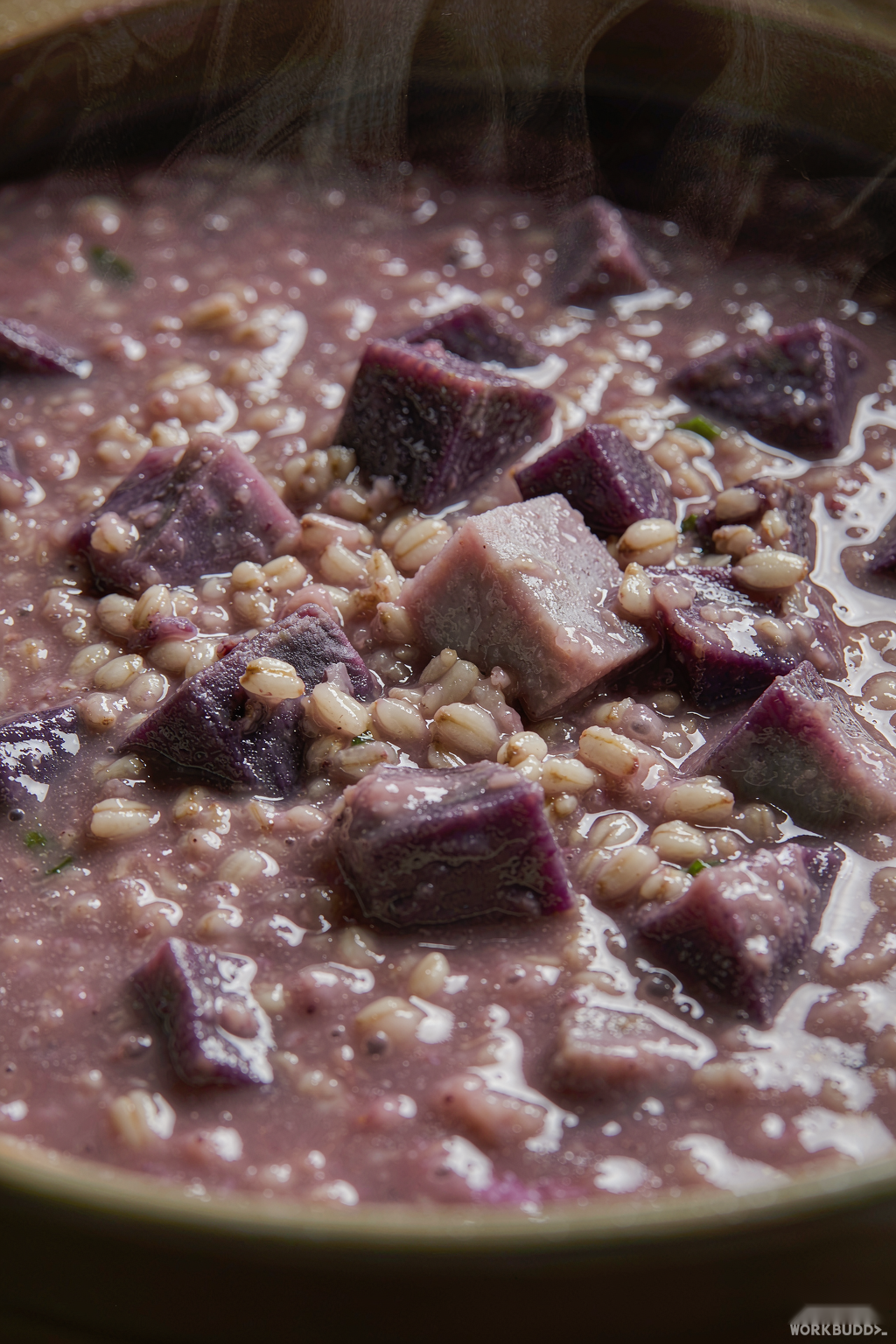 Close-up of creamy purple sweet potato oat porridge texture with visible grain and chunk detail