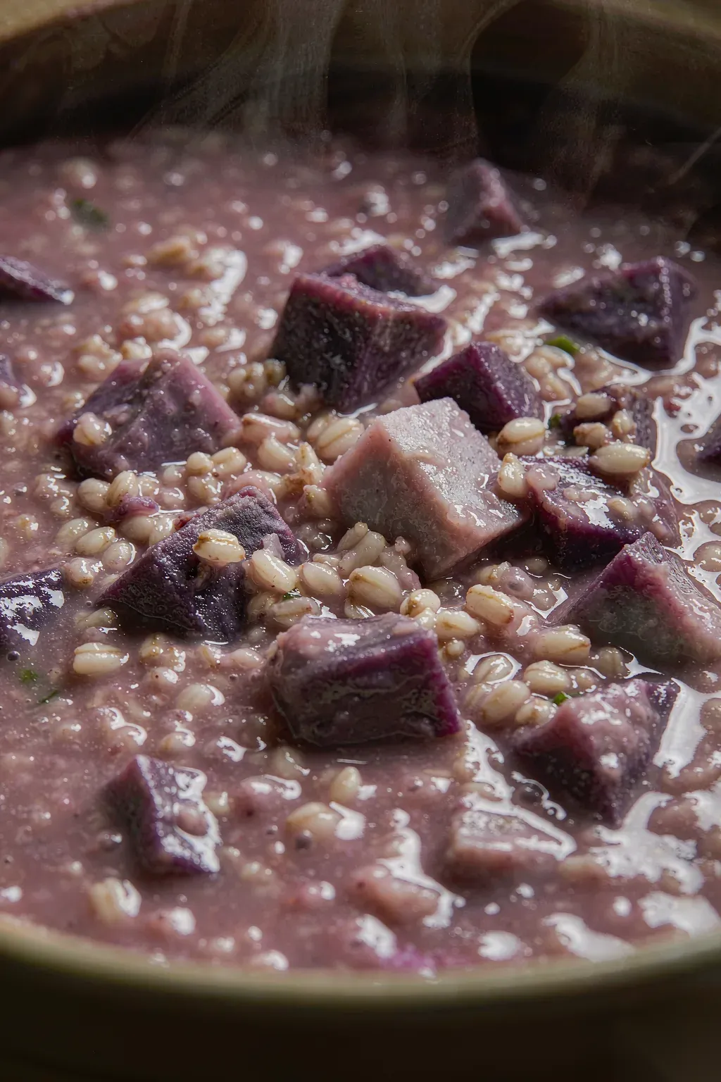 Close-up of creamy purple sweet potato oat porridge texture with visible grain and chunk detail