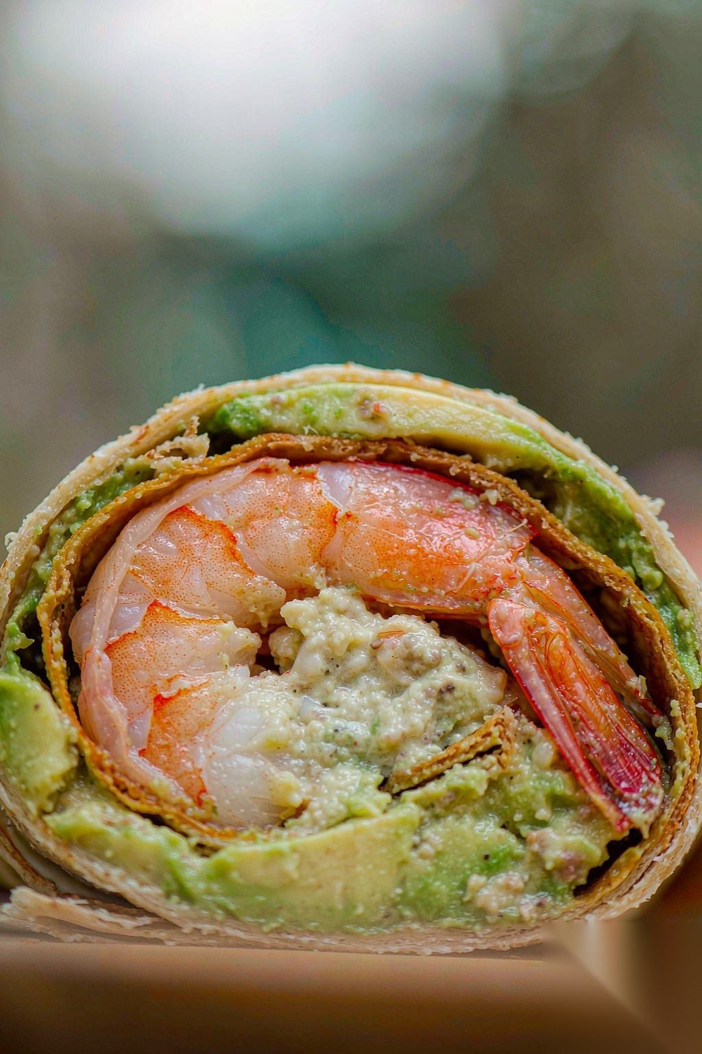 Macro of Shrimp Avocado Wrap cross-section showing shrimp and avocado layers
